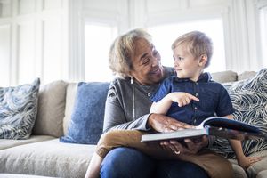 Grandmother reading book with toddler