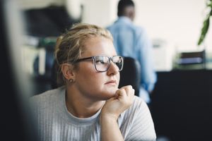 Millennial woman looking pensive.