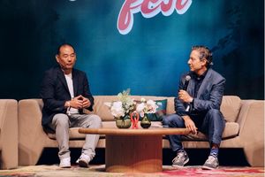 Invesco's Paul Schroeder and Investopedia's Caleb Silver are seated on a stage at Invest Fest 2025 engaged in a discussion.