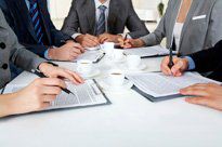 Image of businesspeople’s hands with ballpoint pens, writing on papers while planning work