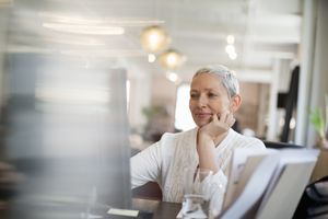 A woman works at a desktop computer.