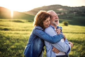 Elderly couple hugging each other in nature