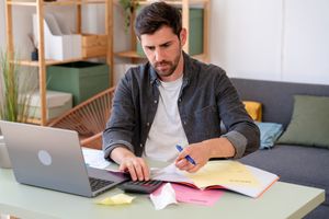 A person looking at ways to pay taxes either with IRS Payment Plan or Personal Loan.