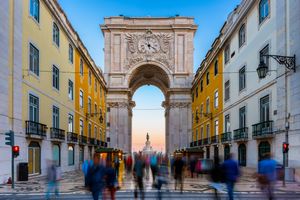Rua Augusta Arch in Lisbon with blurred pedestrians in the foreground