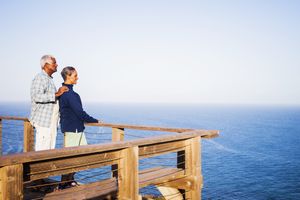 An older couple standing and looking at the ocean